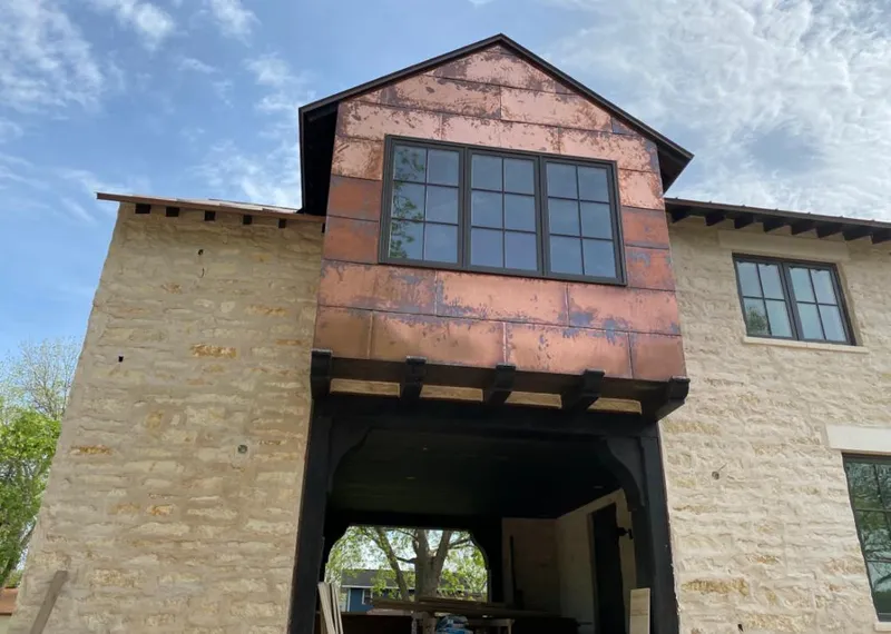 Copper metal panel facade on a stone building for Metal Roof Coating in Madison